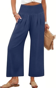 Détail du pantalon bleu foncé à taille haute avec ceinture élastique et poches latérales