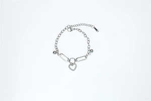 Detail of silver chain bracelet with lobster clasp and sparkling pavé heart charm
