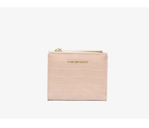 Close-up of pink crocodile pattern leather wallet with gold zipper and embossed logo