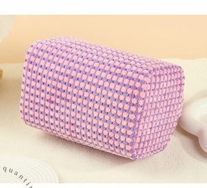 Macro view of purple and pink checkered makeup bag with textured woven grain fabric