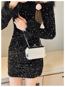 Silver mirror acrylic clutch bag with metal chain shown on a sequined feather dress