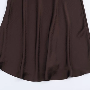 Deep brown satin midi dress showing smooth silky fabric texture and elegant flowing hem