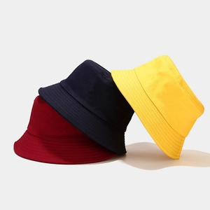 Foldable cotton bucket hats in wine red, navy blue, and yellow with sun protection