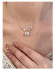 Close-up of S925 silver necklace with square pink zircon pendant on elegant lace model
