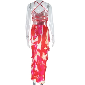 Detail of red and white floral maxi dress featuring a crisscross lace-up back design