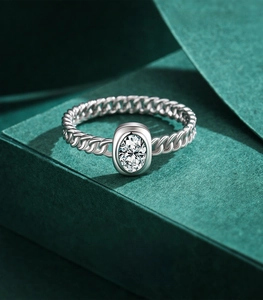 Macro detail of 925 sterling silver chain ring with oval cubic zirconia on velvet box