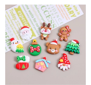 Close-up of 10 colorful Christmas resin charms featuring Santa, reindeer, and gingerbread