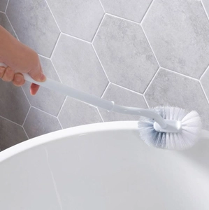 Long-handled curved toilet brush for deep bathroom cleaning on white ceramic surface
