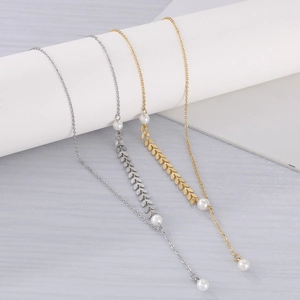 Detail view of wheat leaf pendant necklace with elegant pearls in gold and silver finish