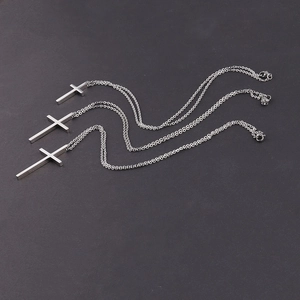 Detailed comparison of three polished stainless steel cross necklaces in various sizes