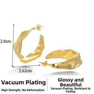 Macro view of gold-plated stainless steel C-shaped earrings with irregular wavy texture