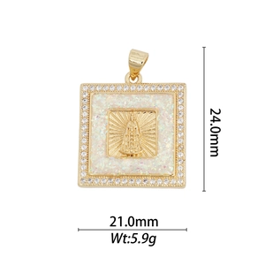 Macro shot of 18k gold religious pendant with Virgin Mary relief and white opal inlay