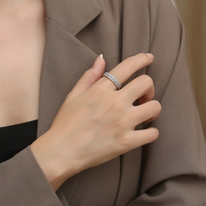 Elegant silver cutout stainless steel ring with wave texture worn on index finger