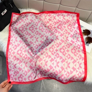 Elegant red and pink silk square scarf with geometric rings on soft white plush background