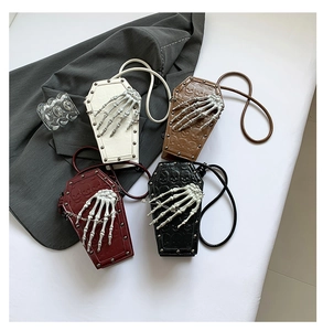 Gothic coffin-shaped PU leather cross-body bags with embossed skulls in four colors