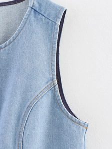 Close-up of blue denim vest showing twill texture and orange contrast stitching details