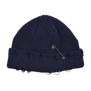 Navy blue ribbed knit beanie with silver safety pin and metal rings in punk style