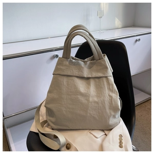 Detailed shot of lightweight nylon tote bag on a black chair with a stylish strap