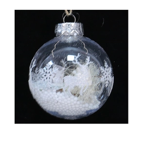 Detailed view of clear Christmas ornament with reindeer, snowflake and snow filling