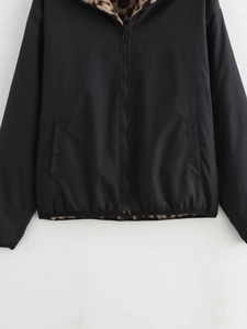 Detail of black hooded bomber jacket with leopard print faux fur lining and zip closure