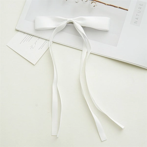 Detailed view of the double-layer white satin bow hair clip with elegant long ribbons
