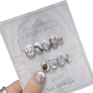 Handmade cat eye press-on nails with 3D cat and bow designs in pearly silver finish