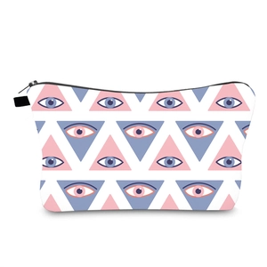 Waterproof travel cosmetic bag with blue and pink evil eye geometric print on white fabric