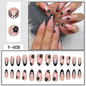 French almond press-on nails with pink base, black tips and small floral patterns