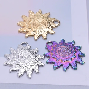 Three sun-shaped stainless steel pendants with spiral texture in gold, silver and rainbow