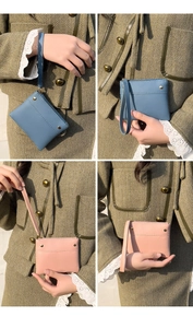 Detail of PU leather coin purses in blue and pink with metal studs and wrist straps