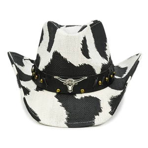 Detail of cow print cowboy hat with gold studs and silver bull head metal ornament