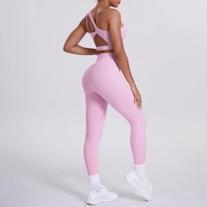 Rear view of pink one-shoulder cutout sports bra and high-waisted yoga leggings