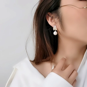 Baroque style pearl earrings with zircon wheat ear details on female model