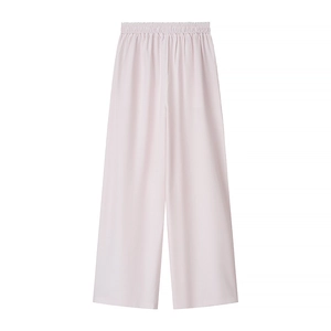 Close-up of light pink wide-leg trousers with elastic high waist and textured fabric