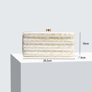 Detail showing dimensions 20.5x10x6cm of white acrylic pearlescent clutch bag