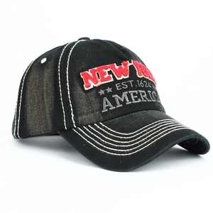 Close-up of black cotton baseball cap with red New York 3D embroidery and white stitching