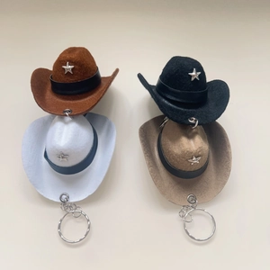 Mini felt cowboy hat keychains with star charms in brown, white, black, and khaki colors