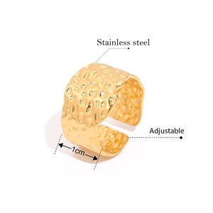 Detail of adjustable 1cm wide golden stainless steel ring with hammered honeycomb texture
