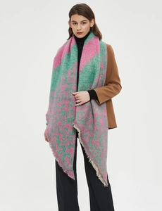 Detail of pink and green leopard print scarf with soft boucle texture and fringe trim