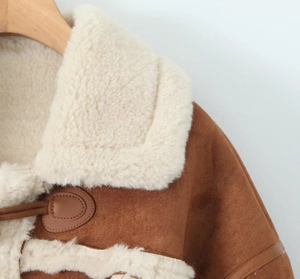 Detail of suede jacket showing lamb wool collar and vintage horn buckle toggle