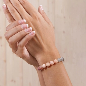 8mm moonstone and sunstone beaded crystal bracelet displayed on a wooden surface