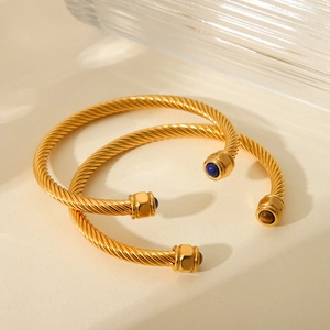 Golden stainless steel cable twist open cuff bracelet with blue and brown gemstones