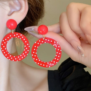 Retro red polka dot resin geometric hoop earrings for women shown worn on model's ear