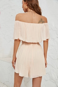 Rear view of elegant off-shoulder jumpsuit with pleated texture in nude color