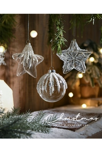 Detailed view of clear Christmas ornaments with white beads and sequins on pine branches