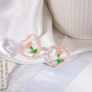 Pink heart tulip earrings with white pearls on white silk background, sweet floral style