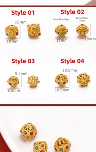 Macro detail of gold filigree spacer beads with colored inlays for DIY jewelry making