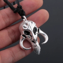 Macro shot of Mandalorian Mythosaur skull necklace with vintage silver finish and black cord