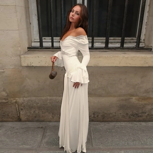 Detail showing white lace trim and ruffled sleeves on a V-neck slim-fit dress
