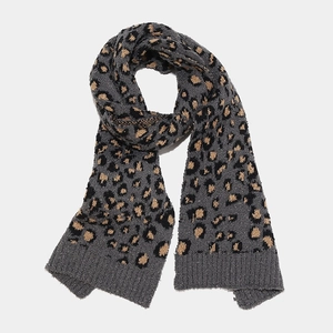 Detail of soft leopard print knit scarf with thick fleece texture and ribbed cuffs